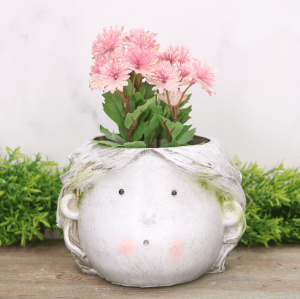 Osłonka ceramiczna "Twarz dziewczynki" omszona 12cm 